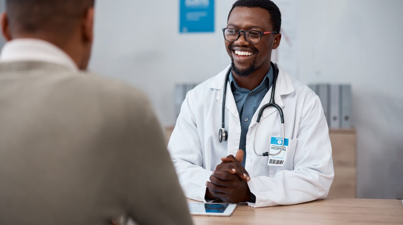 Home Services In Dubai 24 Black man doctor with patient in consultation office for healthcare advice, services and profession